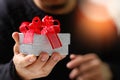 gift giving,man hand holding a gift box in a gesture of giving.blurred background,bokeh effect Royalty Free Stock Photo