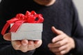gift giving,man hand holding a gift box in a gesture of giving.blurred background,bokeh effect Royalty Free Stock Photo