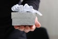 gift giving,man hand holding a gift box in a gesture of giving.blurred background,bokeh effect Royalty Free Stock Photo