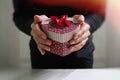 gift giving,man hand holding a gift box in a gesture of giving.blurred background,vintage effect Royalty Free Stock Photo