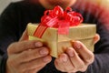 gift giving,man hand holding a gift box in a gesture of giving.blurred background,vintage effect Royalty Free Stock Photo