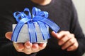 gift giving,man hand holding a gift box in a gesture of giving.blurred background,vintage effect Royalty Free Stock Photo
