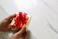 gift giving,man hand holding a gift box in a gesture of giving o Royalty Free Stock Photo