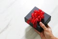 gift giving,man hand holding a gift box in a gesture of giving o Royalty Free Stock Photo