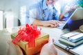 Gift Giving.Patient hand or Team giving a gift to a surprised Me Royalty Free Stock Photo