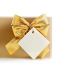 Gift with gold bow and blank label Royalty Free Stock Photo
