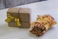 Gift with gold ribbon and a bag of wafer rolls Royalty Free Stock Photo