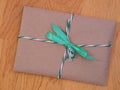 Gift with a green bow on a wooden background