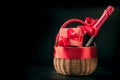 Gift hamper, red gift, bottle of champagne on black. Isolated. Romantic present