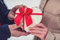 Gift hearts - Man gives a box with a gift to his girlfriend,