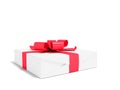 Gift wrapped in white paper with red bow and ribbons small for g Royalty Free Stock Photo