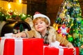 Gift kid emotions. New year Christmas concept. Happy kid having fun with big gift box. Kid having fun near Christmas Royalty Free Stock Photo