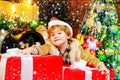 Gift kid emotions. New year Christmas concept. Happy kid having fun with big gift box. Kid having fun near Christmas Royalty Free Stock Photo