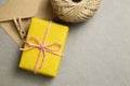 Gift box and kraft envelopes on gray background