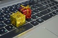 Gift lies on the laptop keyboard. Online gifts. A gift during a pandemic