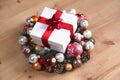 A gift lying on the Christmas wreaths on the