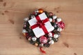 A gift lying on the Christmas wreaths on the