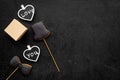 Gift for man on birthday. Gift box among cookies in shape of hat, bow tie and hearts with lettering love you on black Royalty Free Stock Photo