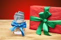 Gift and money on a wooden table Royalty Free Stock Photo