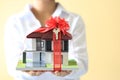 Gift new home and Real estate concept, Female man hands holding model house with red ribbon and the car with keys Royalty Free Stock Photo