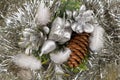 Gift and pine cones on a silvery tinsel
