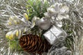 Gift and pine cones on a silvery tinsel