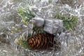 Gift and pine cones on a silvery tinsel