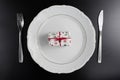 Dinner Setting with Gift. Suprize eating or gift dinner concept Royalty Free Stock Photo