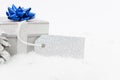 Gift or present with blank empty tag label on winter snow Royalty Free Stock Photo
