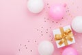 Gift or present box, balloons and confetti on pink table top view. Flat lay composition for birthday, mother day or wedding. Royalty Free Stock Photo