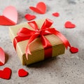 Gift Present box of craft paper with red ribbon, red hearts. Valentine`s Day concept. Square image