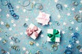 Gift or present box decorated colorful confetti, star and streamer on blue vintage table top view. Flat lay style. Christmas.