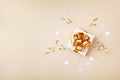 Gift or present box and stars confetti on golden table top view. Flat lay composition for birthday, christmas or wedding