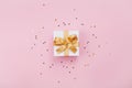 Gift or present box and stars confetti on pink pastel table top view. Flat lay composition for birthday, mother day or wedding. Royalty Free Stock Photo