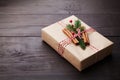 Gift or present box wrapped in kraft paper with christmas decoration on vintage wooden table. Copy space for text. Royalty Free Stock Photo