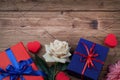 Gift or present boxes with red and blue bow ribbon, hearts and flowers on wooden background for Valentines day. copy space top vie Royalty Free Stock Photo