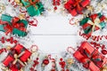 Gift or present boxes, snowy fir tree and christmas decorations on white wooden table top view. Flat lay Royalty Free Stock Photo