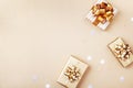 Gift or present boxes and stars confetti on golden table top view. Flat lay composition for birthday, christmas or wedding