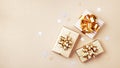 Gift or present boxes and stars confetti on golden table top view. Flat lay composition for birthday, christmas or wedding