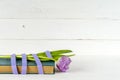 Gift, purple tulips and book over wooden table