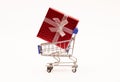 A gift in a red box tied with a banot rides in a metal trolley on wheels Royalty Free Stock Photo