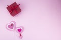 Gift with a red ribbon on a pink background. Red gift box tied with a satin ribbon on a pink background Royalty Free Stock Photo