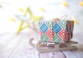Gift with ribbon on wooden sled for Christmas on background with lights and decoration star, Christmas time concept Royalty Free Stock Photo