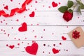 Gift, rose and red hearts on white wooden background, top view. Copyspace, a Valentine`s Day concept Royalty Free Stock Photo
