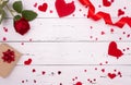 Gift, rose and red hearts on white wooden background, top view. Copyspace, a Valentine`s Day concept Royalty Free Stock Photo
