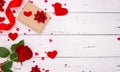 Gift, rose and red hearts on white wooden background, top view. Copyspace, a Valentine`s Day concept Royalty Free Stock Photo