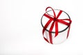 Gift round white box with a red bow on a light background. surprise for christmas and new year. birthday present macro Royalty Free Stock Photo