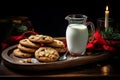 A gift for Santa Claus. A glass of milk cookies with chocolate on a red napkin on the table, candles. Waiting for a Royalty Free Stock Photo