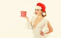 Gift from santa. Woman attractive lady wear sexy dress and santa hat. Girl hold cute box opening christmas gift. Girl Royalty Free Stock Photo