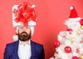 Gift service. Head downtrodden with thoughts what to gift. Man bearded formal suit carry gift box on head. Christmas Royalty Free Stock Photo